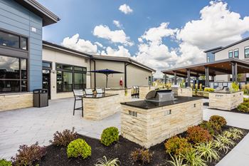 Spacious patio with sitting arrangements with bbq
